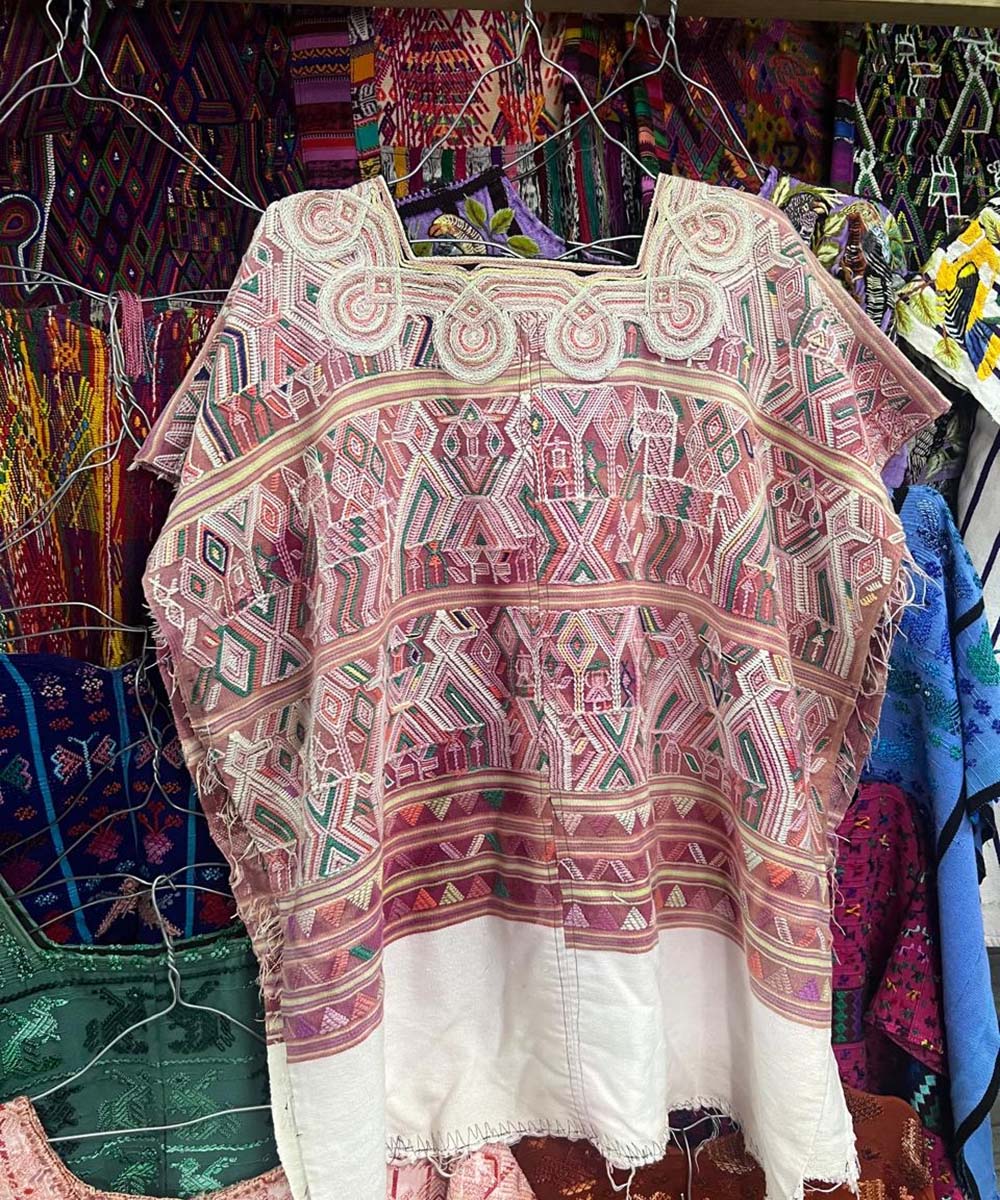 Aged red Nebaj huipil with scroll neckline