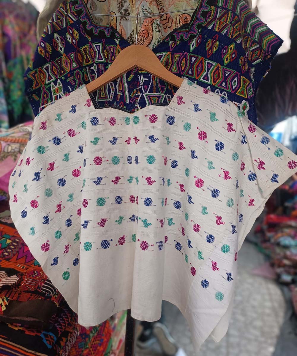 White huipil with colourful embroidery