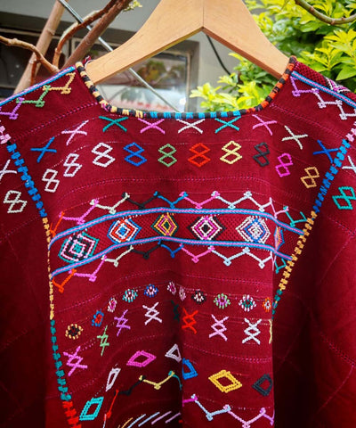 Colorful on red Colotenango huipil