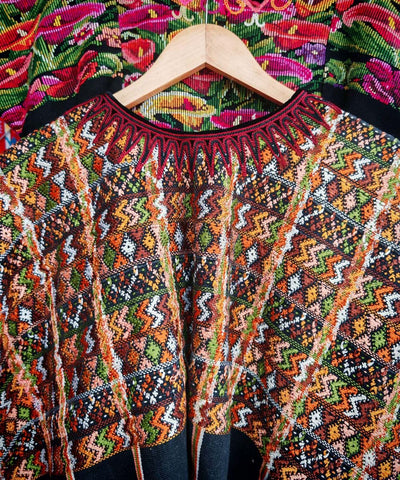 Orange and black zigzag huipil