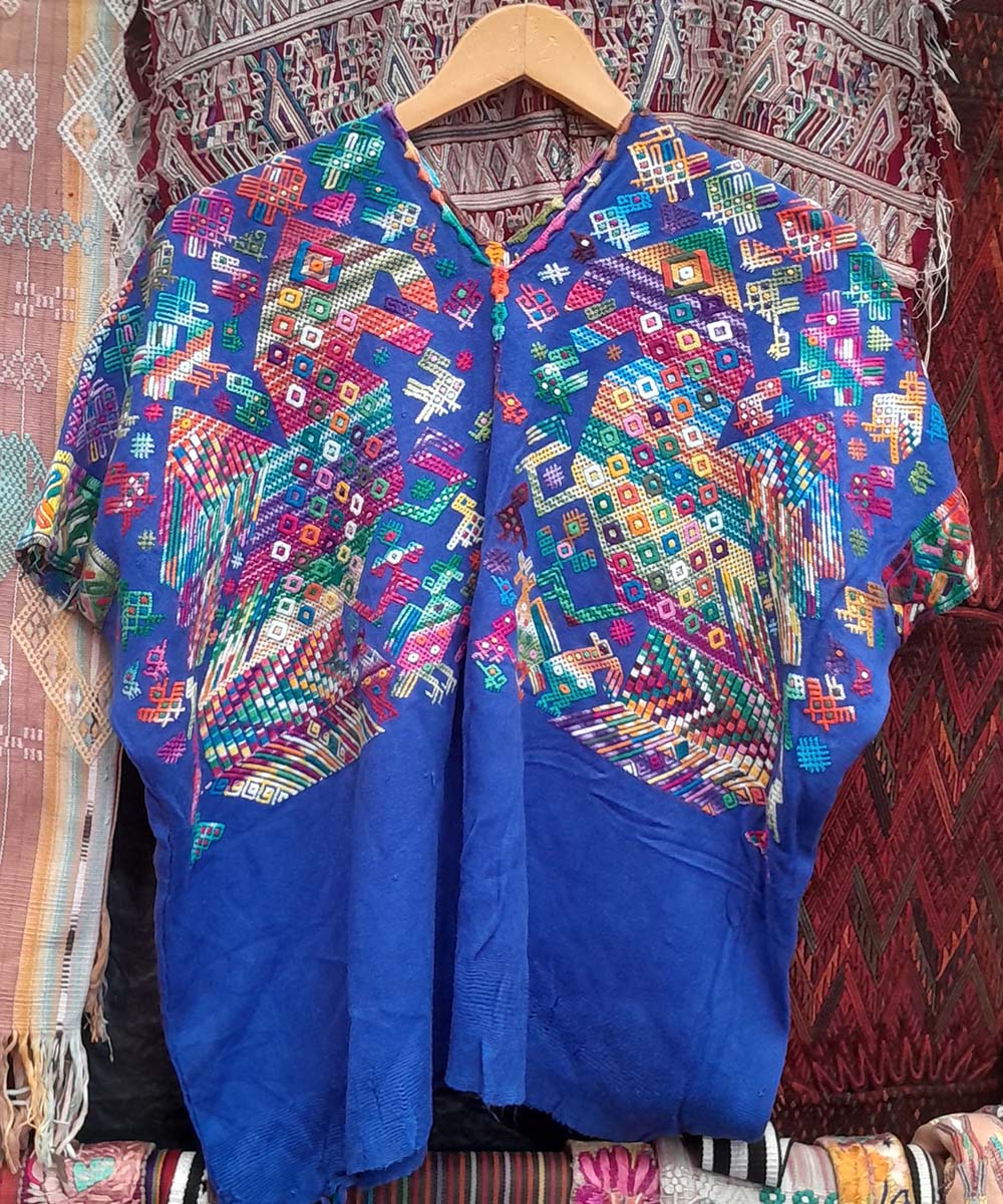 Bright blue Nahuala huipil with quetzales