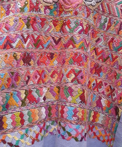 Blue and pink San Juan Cotzal huipil