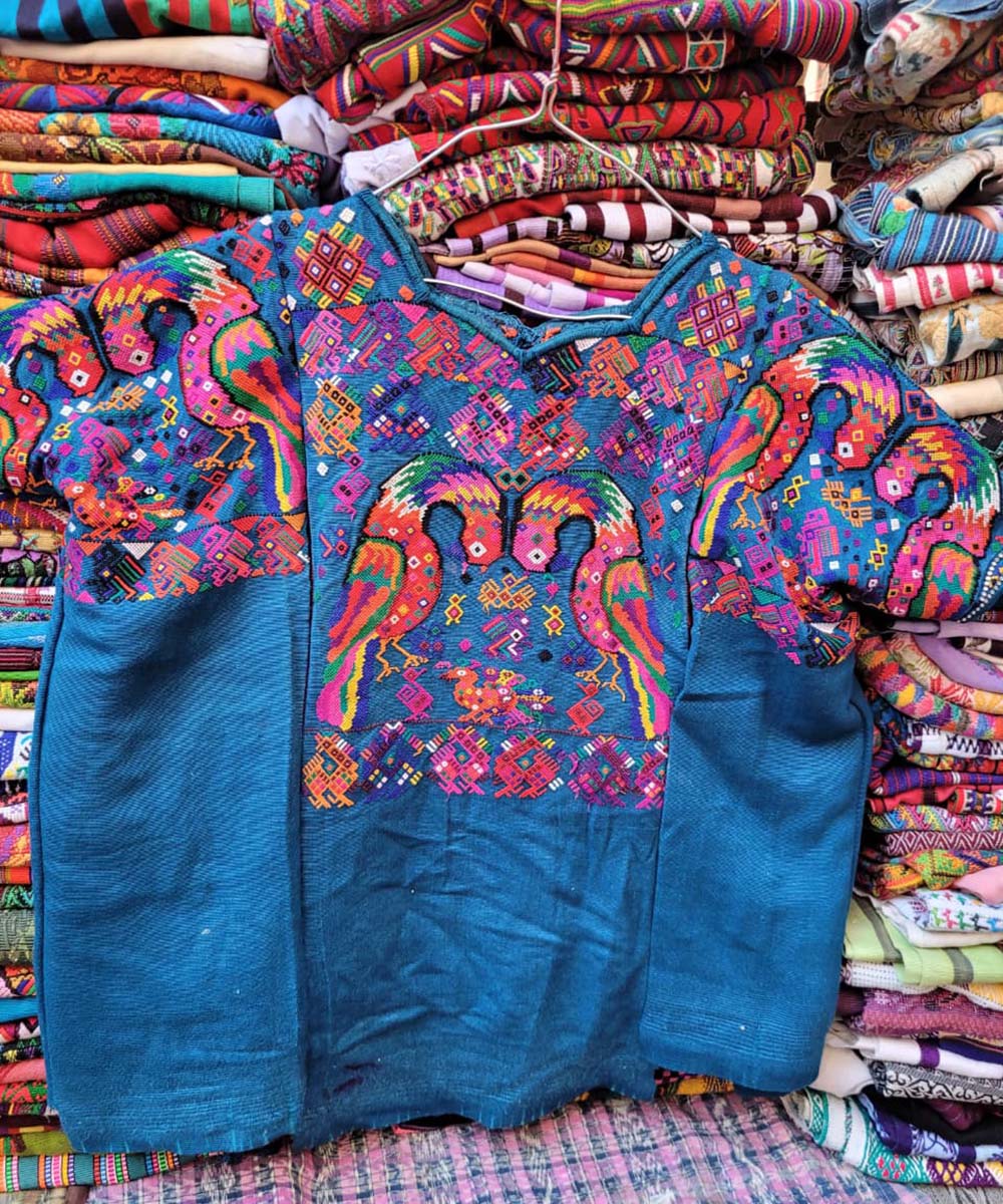 Blue Chichi huipil with playful peacocks