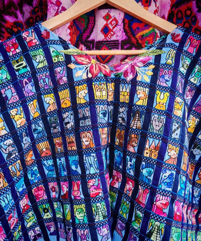 Blue Santiago huipil with Mayan figures