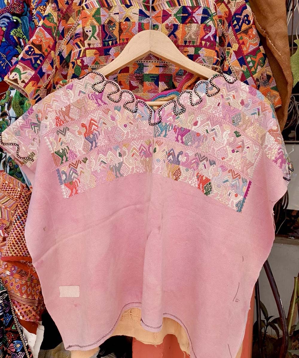 Pale pink Nahuala huipil with colourful embroidery