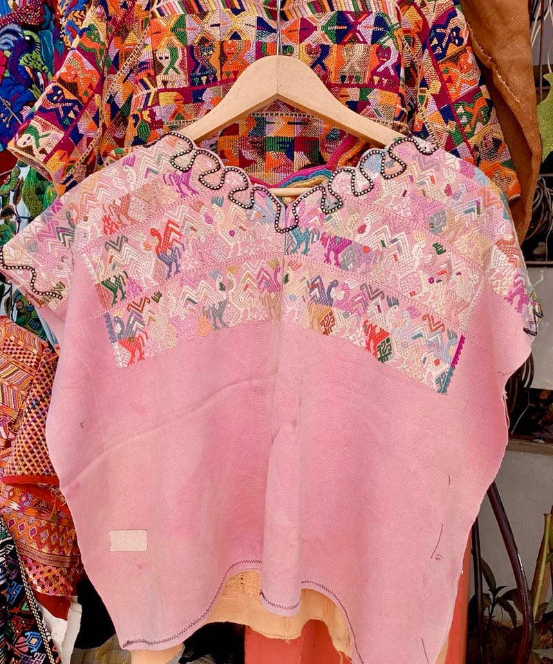 Pale pink Nahuala huipil with colourful embroidery