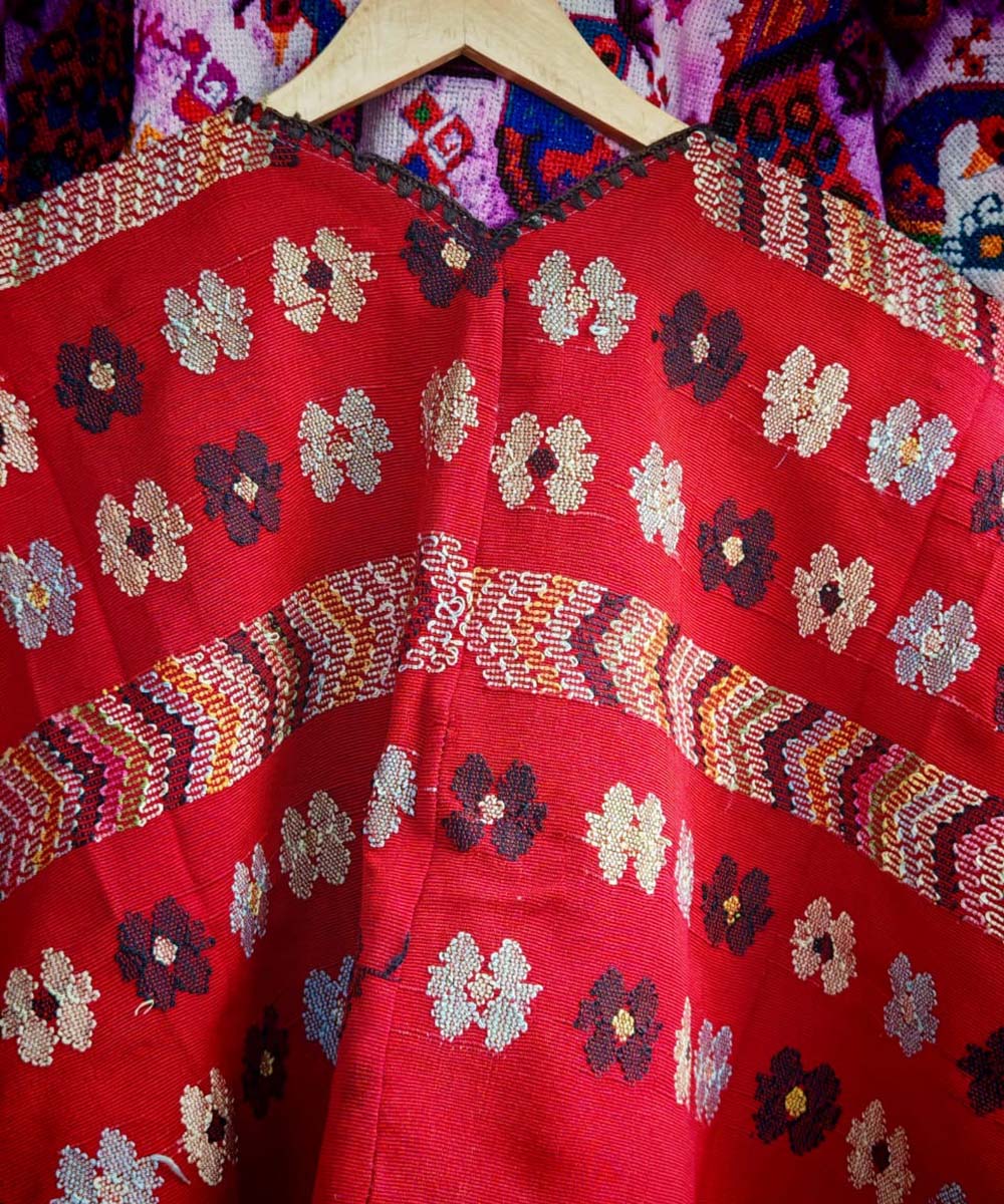 Red huipil with playful flowers