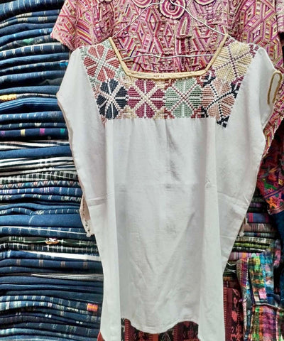 White huipil with colorful neckline