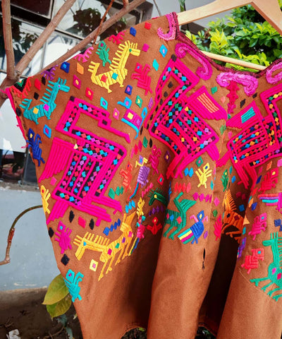Brown and pink Chichi huipil with stylised animals
