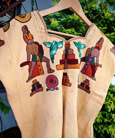 Yellow huipil with ceremonial Mayan men