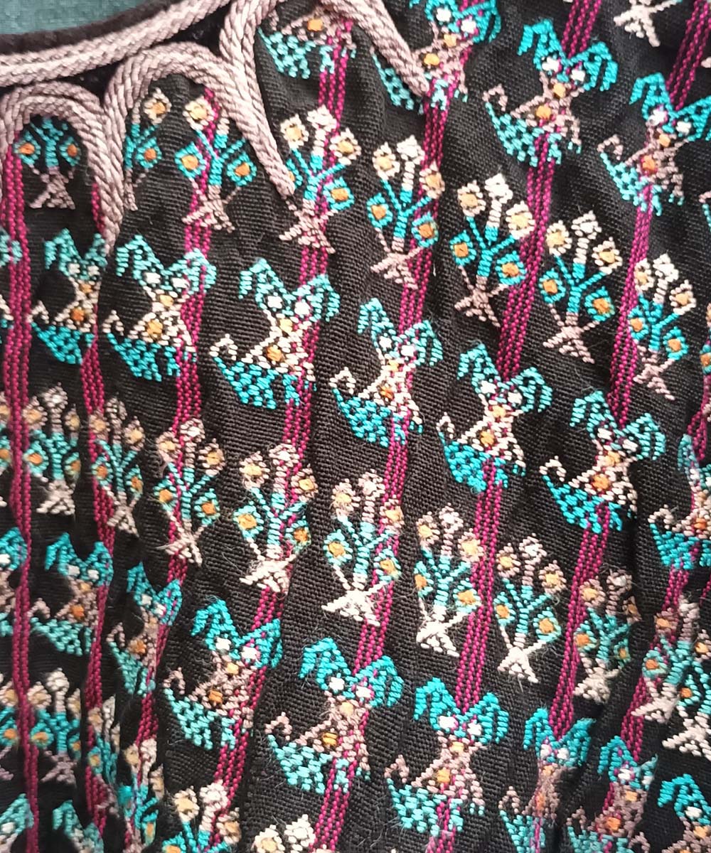 Black and pink Nahuala huipil with turquoise puppies