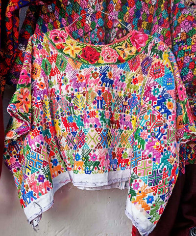 Colorful on white Coban huipil