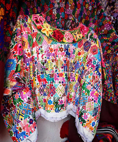 Colorful on white Coban huipil