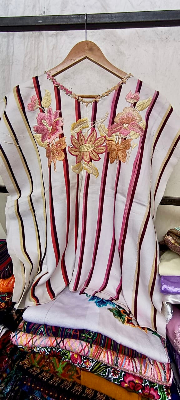 White floral Santiago huipil with pink and gold stripes