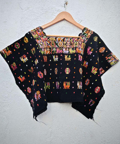 Black Coban huipil with colorful motifs