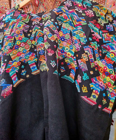 Colorful on black Nahuala huipil with horses