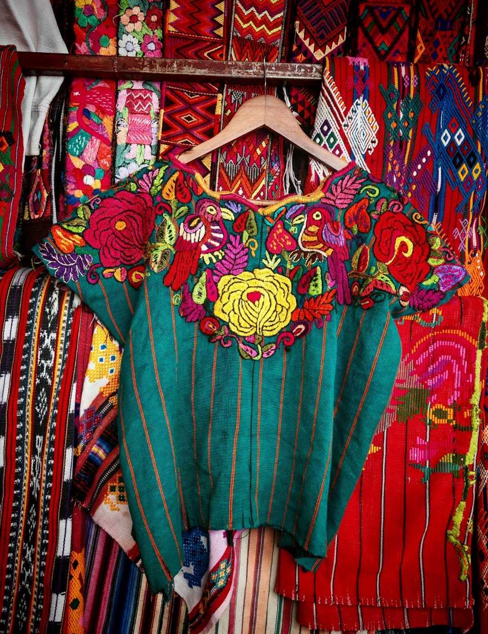 Floral parrots on green Chichicastenango huipil #6-96