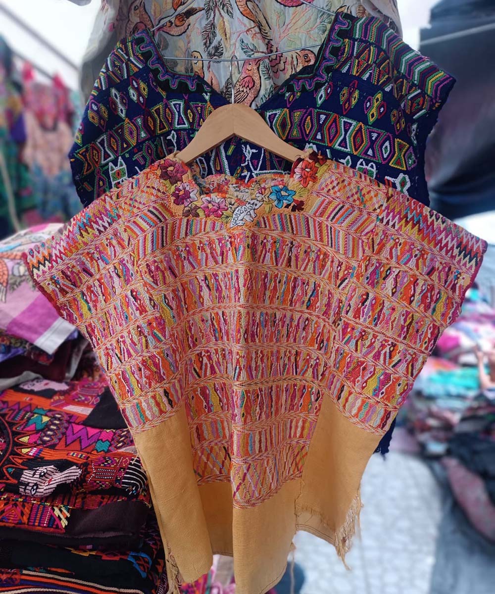 Pink and yellow San Juan Cotzal huipil