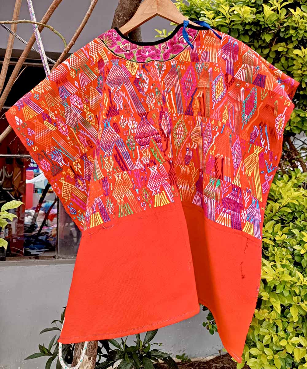 Bright orange huipil with bird motifs