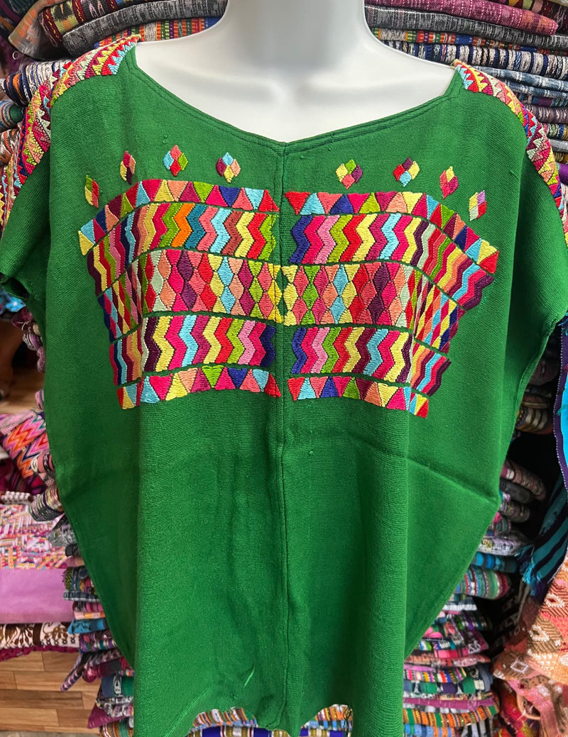 Light green background with geometric designs in different colors Chajul Huipil #8-342