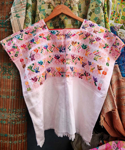 Pink Nahuala huipil with stylised flowers