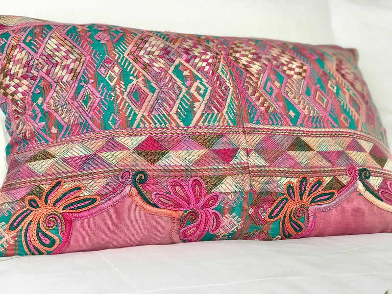 Guatemalan embroidered huipil pillow. A pink and turquoise striped vintage textile with stylised horses.