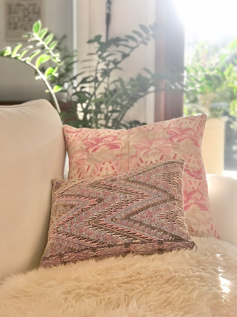 Guatemalan embroidered huipil pillow. Abstract flowers in a pale pink and white palette.