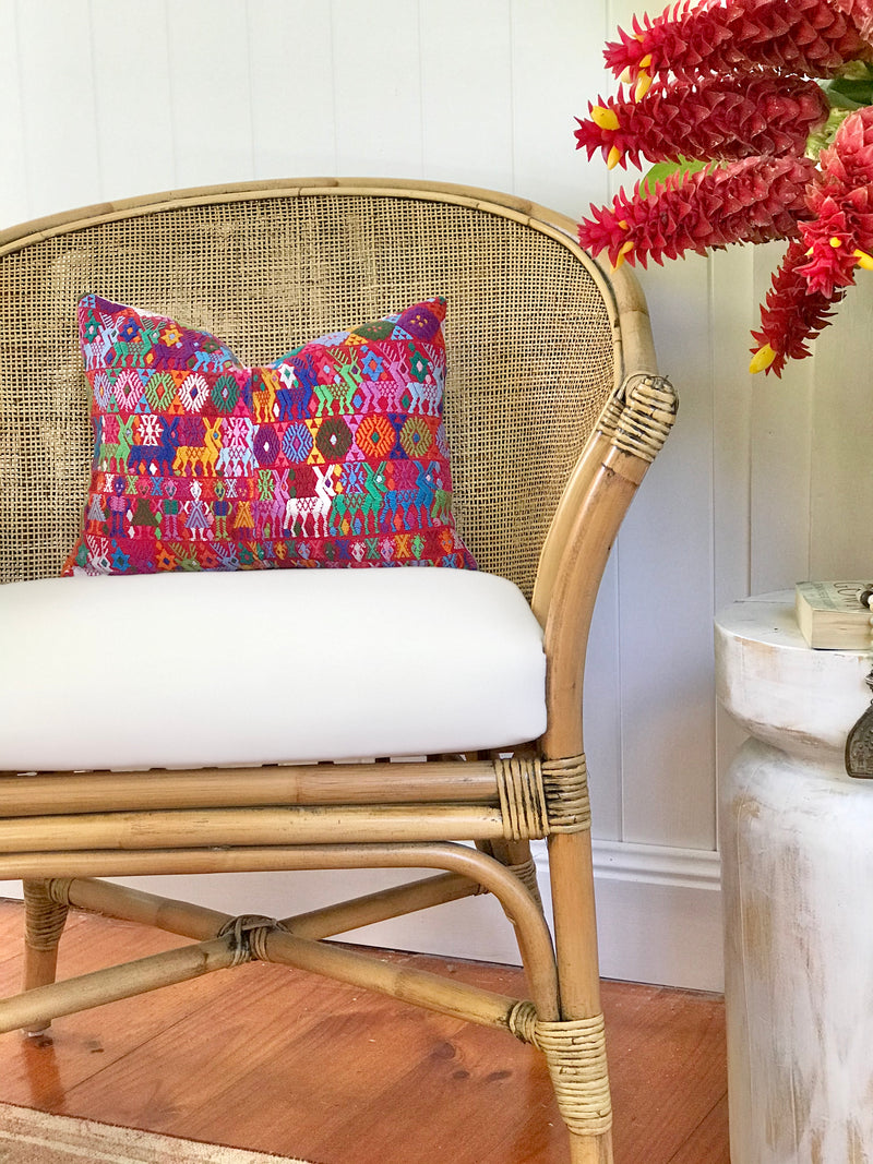 Guatemalan Huipil Pillow, vintage, hand embroidered Coban textile of brightly coloured tribal figures over a red cotton