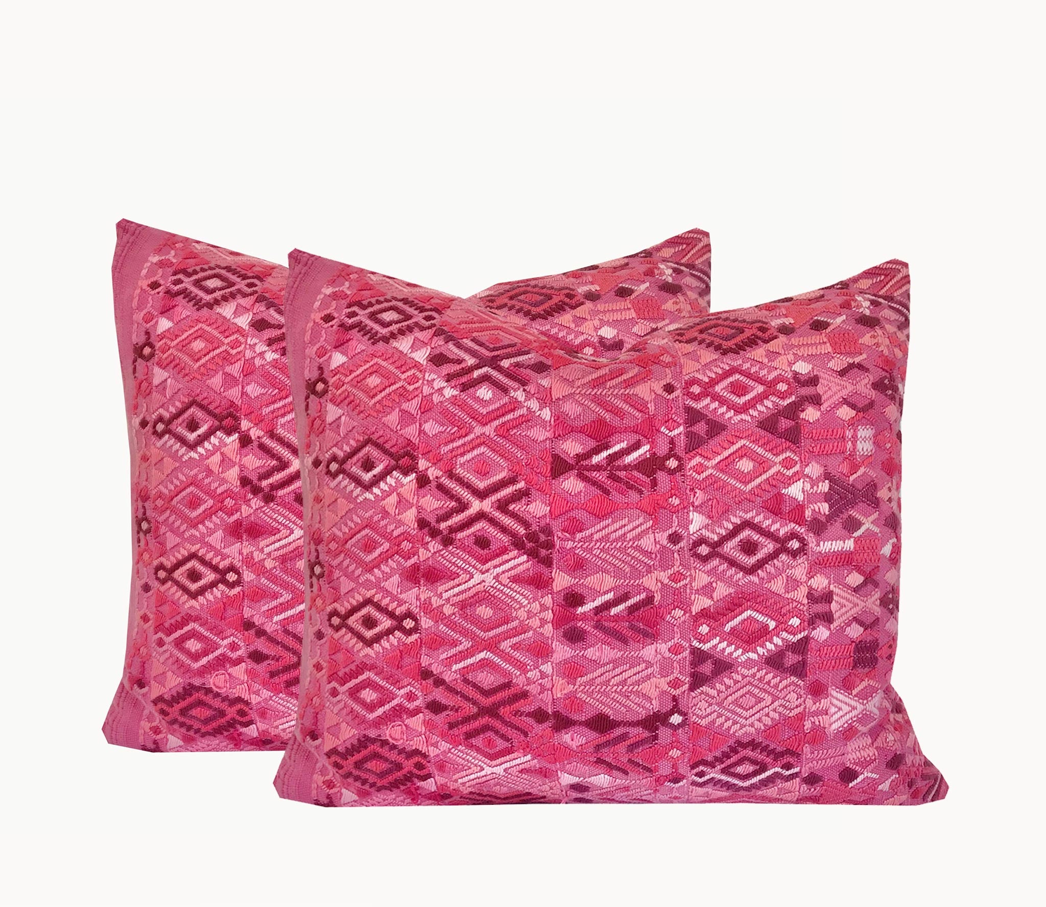 A pair of Guatemalan Huipil Pillows, vintage, hand embroidered textiles in bright pink with a playful tribal design